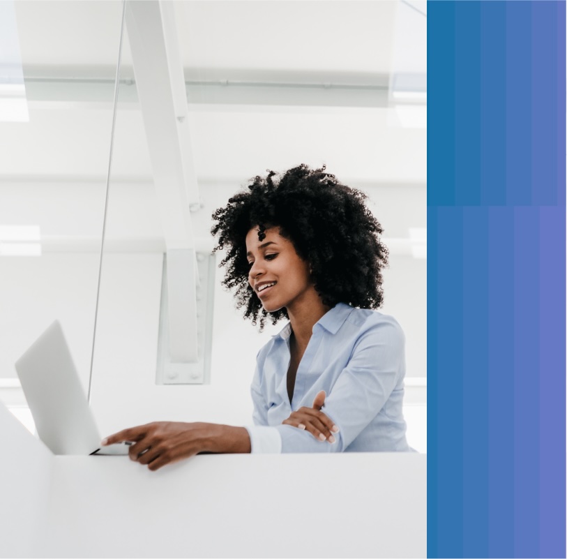 Woman works on her laptop at her office desk.