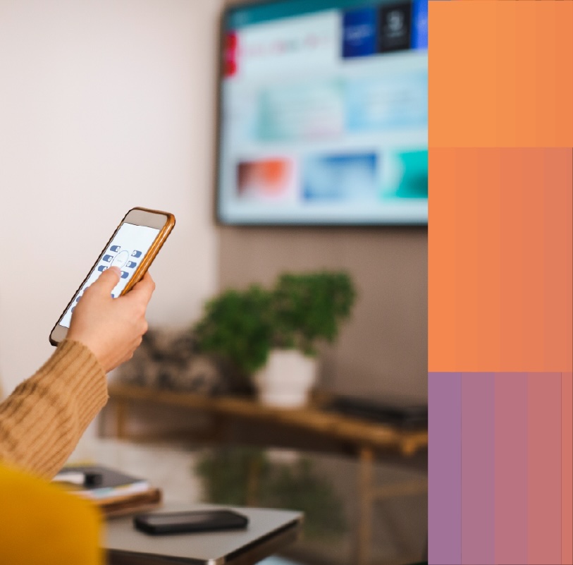 Photo of a television viewer configuring their set's privacy and consent preference center with their mobile phone.